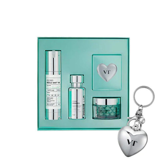 Cosmetic set with bottles and a jar in a green box, featuring a heart-shaped keychain with 'VT' on a white background.