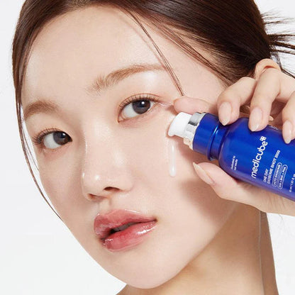 Woman applying a blue skincare product to her face