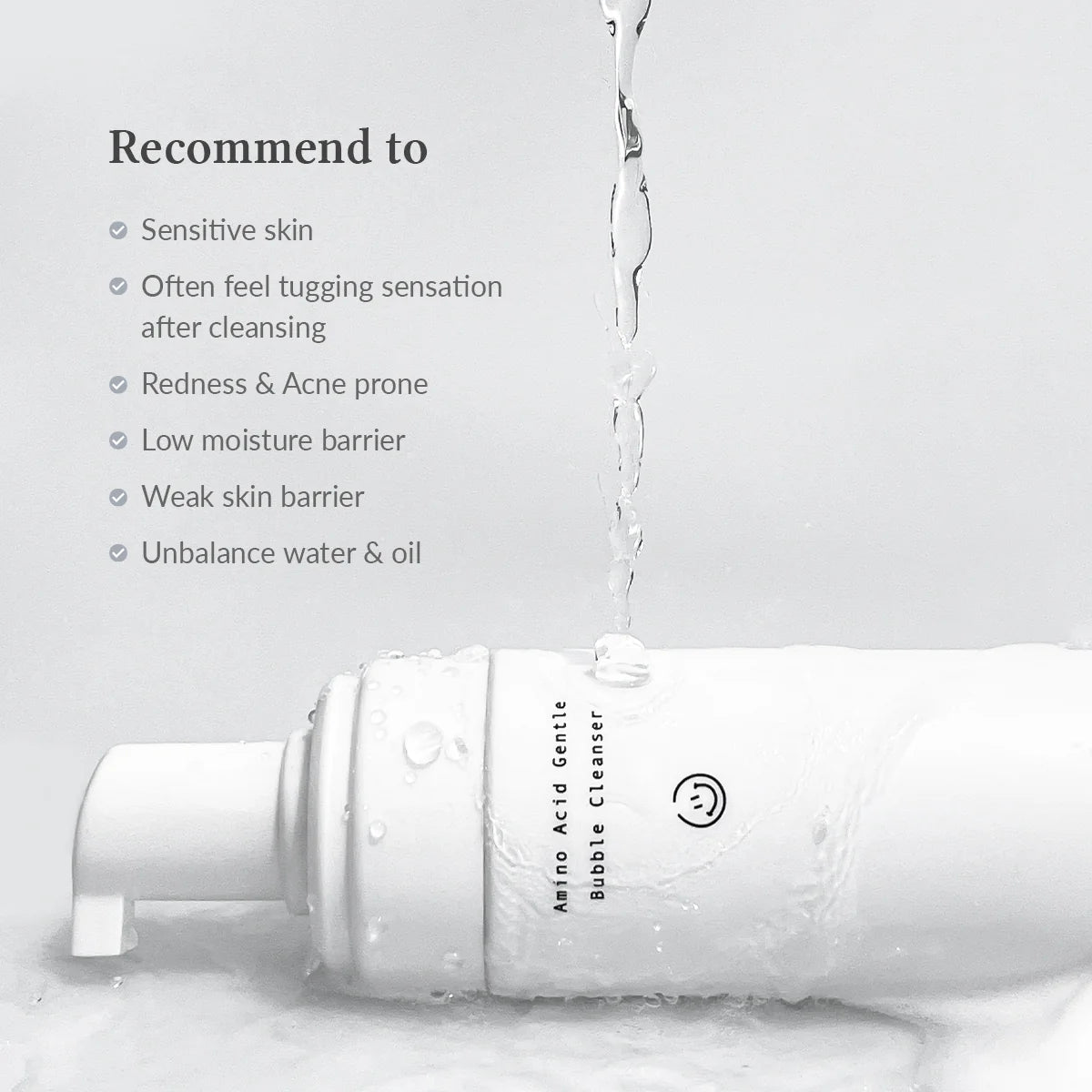 Bottle of Amino Acid Gentle Bubble Cleanser with water droplets on a light gray background
