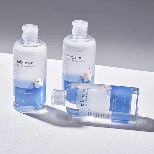 Three bottles of mixsoon skincare product on a gray background