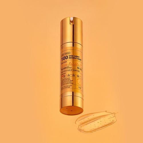 Gold skincare serum bottle on a matching orange background