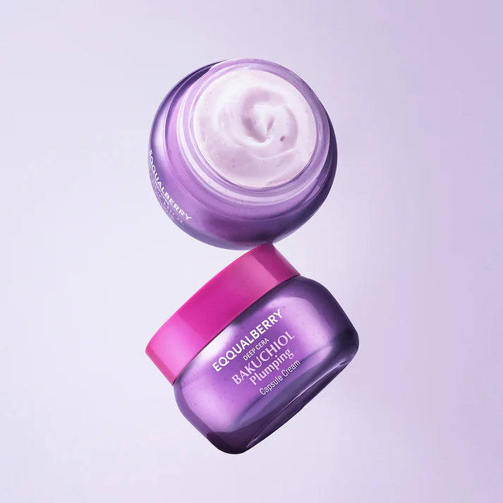 Two purple jars of cream with pink lids on a light purple background
