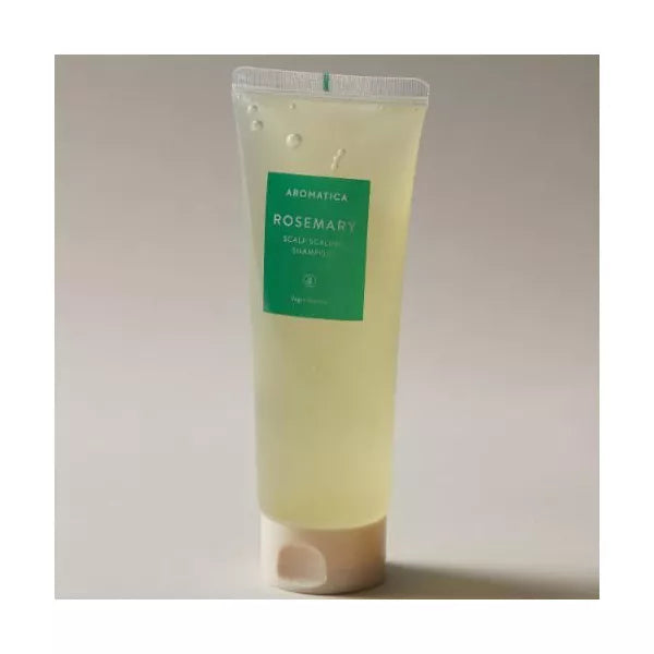 Tube of Aromatica Rosemary body scrub on a light gray background