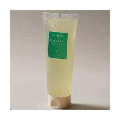 Tube of Aromatica Rosemary body scrub on a light gray background