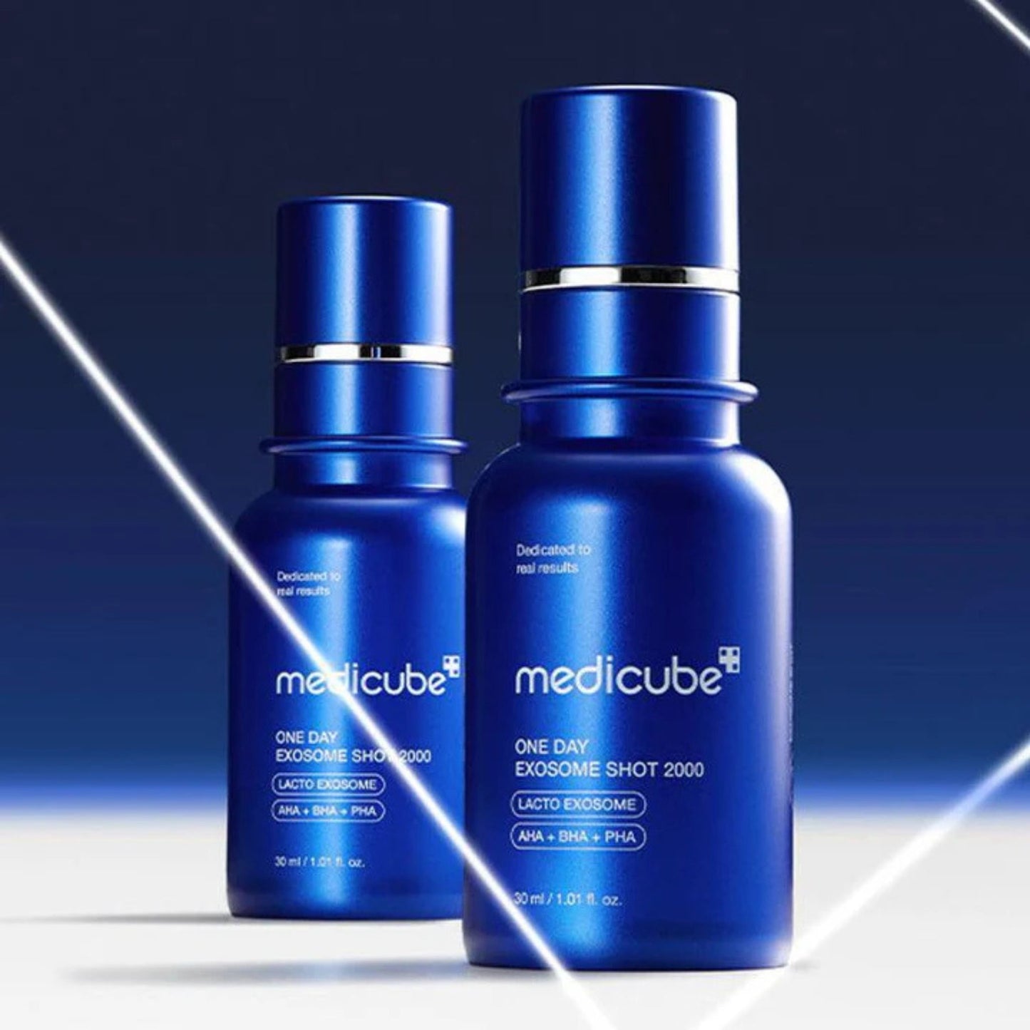 Two blue bottles of Medicube skincare product on a gradient background