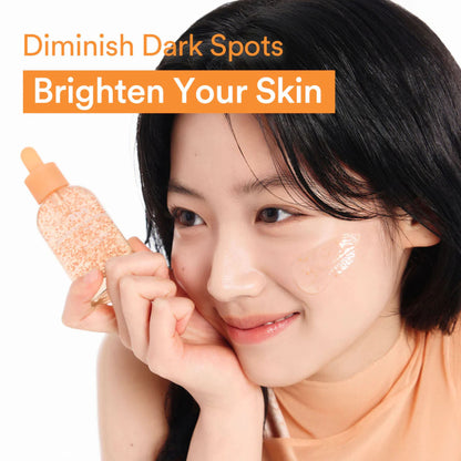 Woman holding a skincare product with text 'Diminish Dark Spots Brighten Your Skin' on a white background