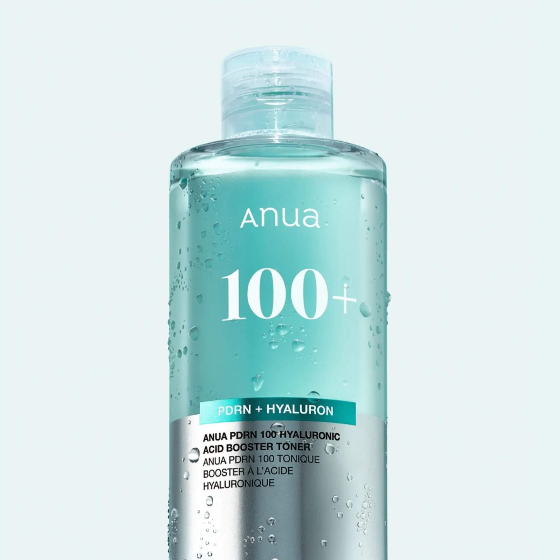 Anua 100+ toner bottle on a light gray background