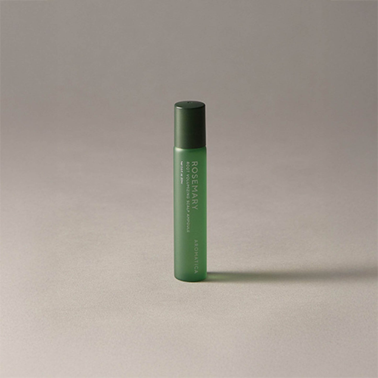 Green cylindrical bottle with text on a beige background