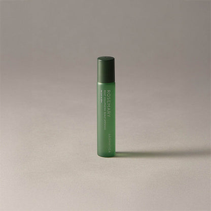 Green cylindrical bottle with text on a beige background