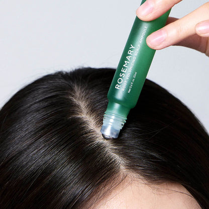 Person using a green roll-on product on their hair