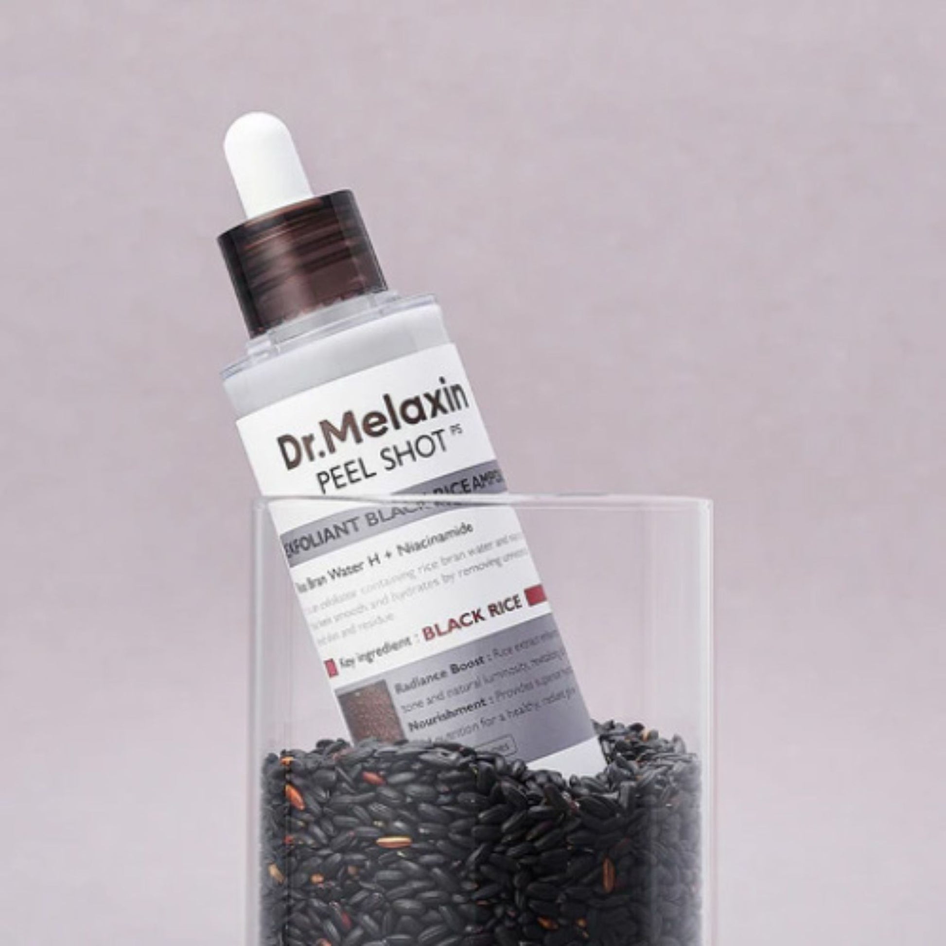 Dr. Melaxin skincare product with black rice on a light gray background