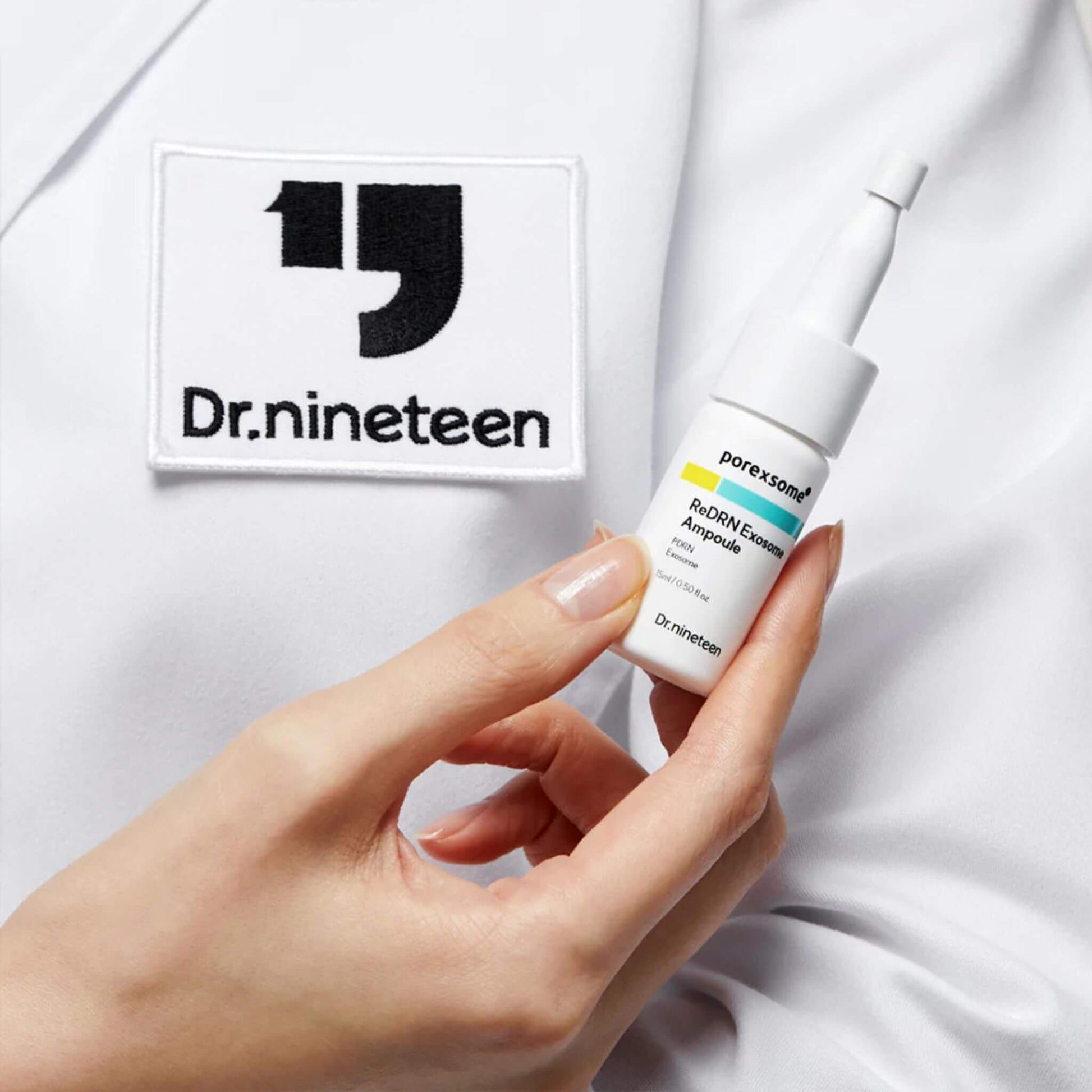 Dr. nineteen skincare product held by a hand with a white background
