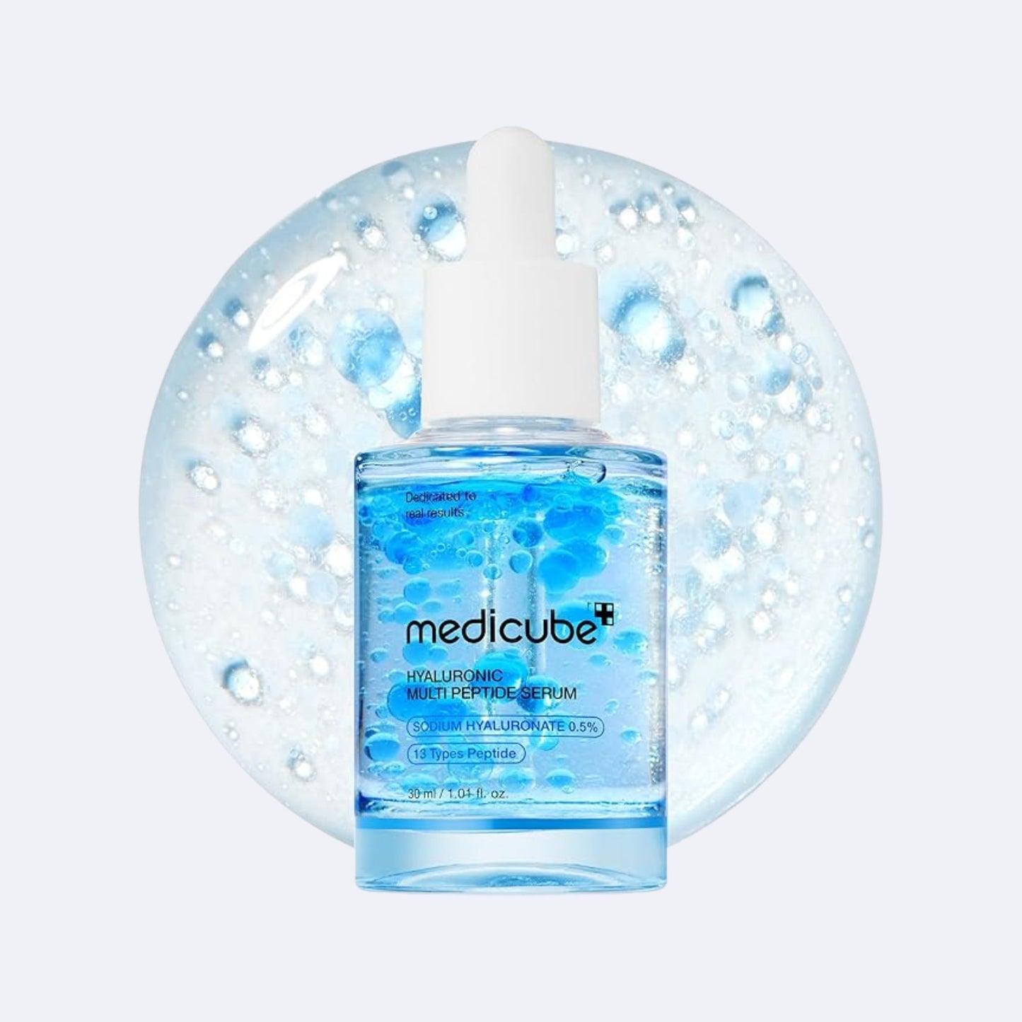 Medicube serum bottle with dropper on a light blue background