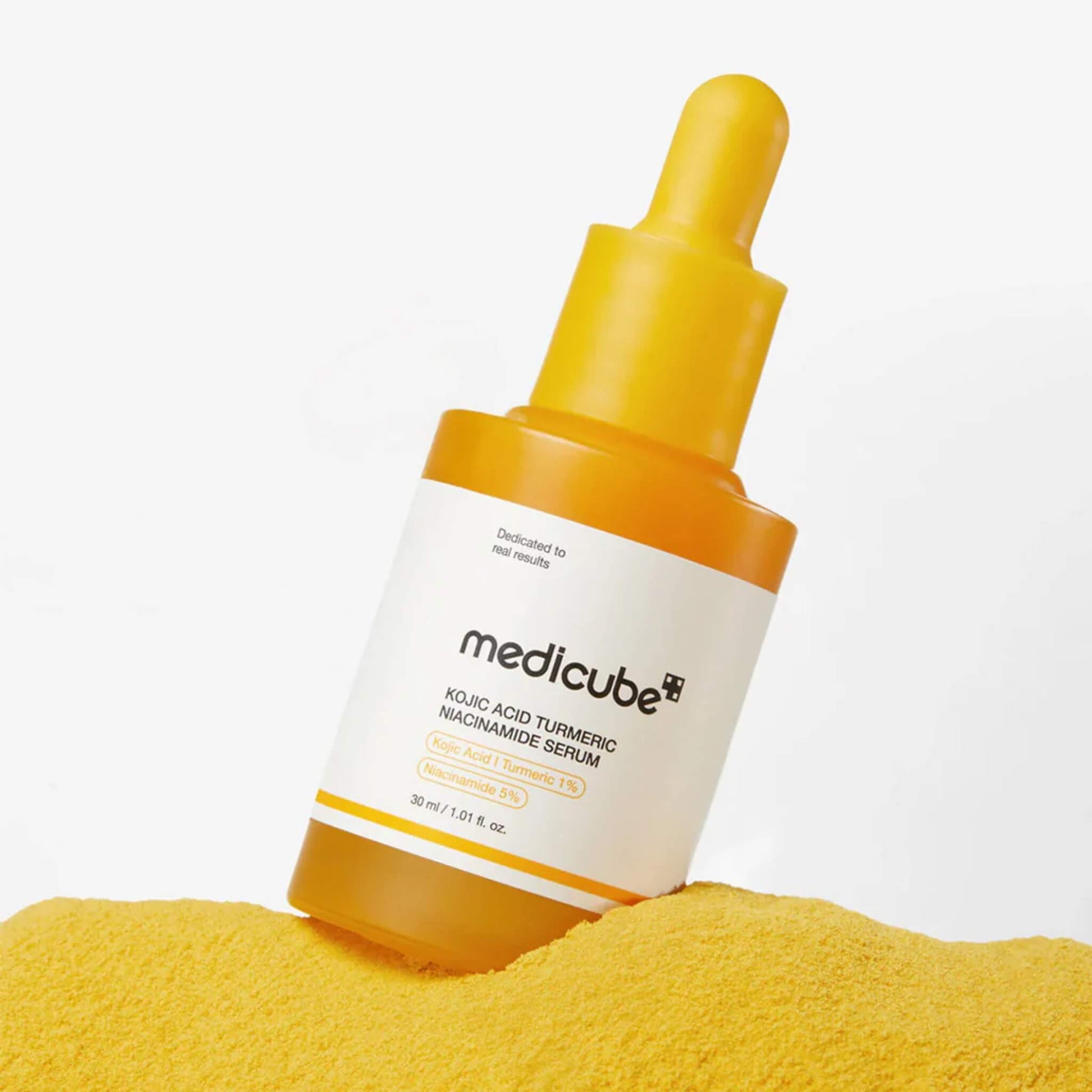 Medicube skincare serum bottle with yellow dropper on a white background