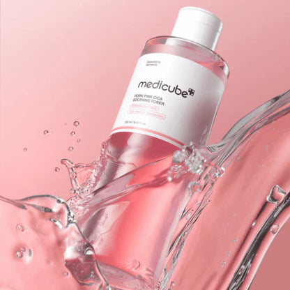 Medicube toner bottle with water splashes on a pink background