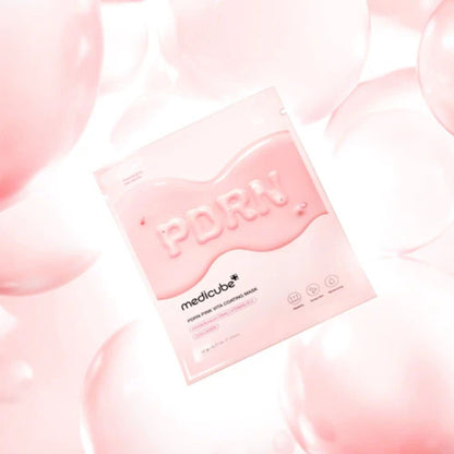 Pink sheet mask packaging with 'medicube' branding on a soft pink background