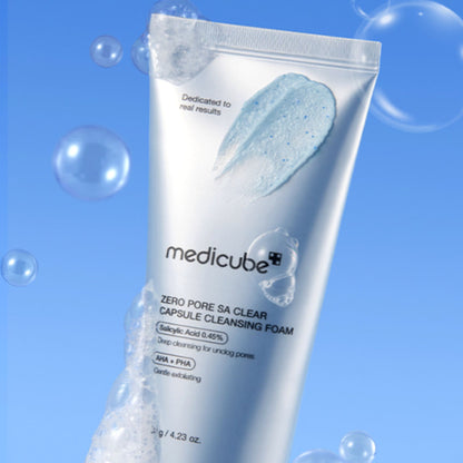 Tube of Medicube Zero Pore SA Clear Capsule Cleansing Foam on a blue background with bubbles.