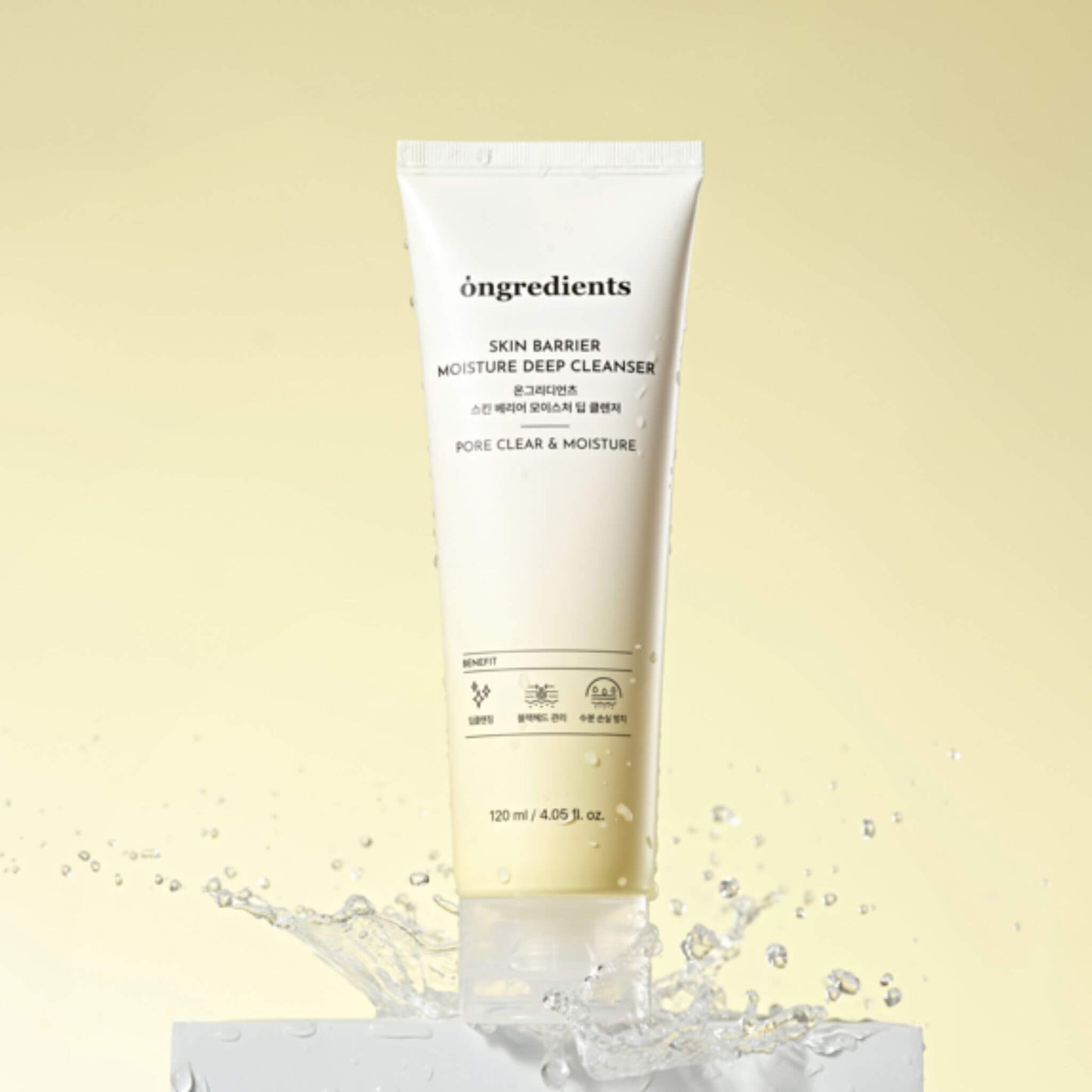 Skincare cleanser tube labeled 'ongredients' on a light yellow background with water droplets.