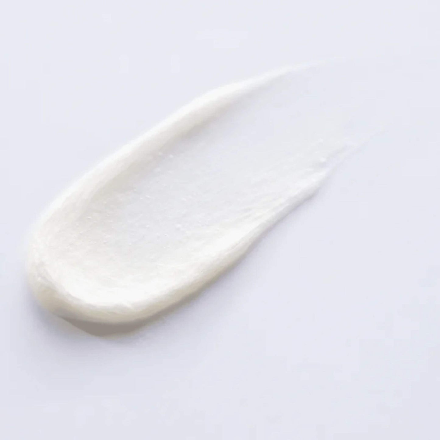 White cream or paint swatch on a light gray background