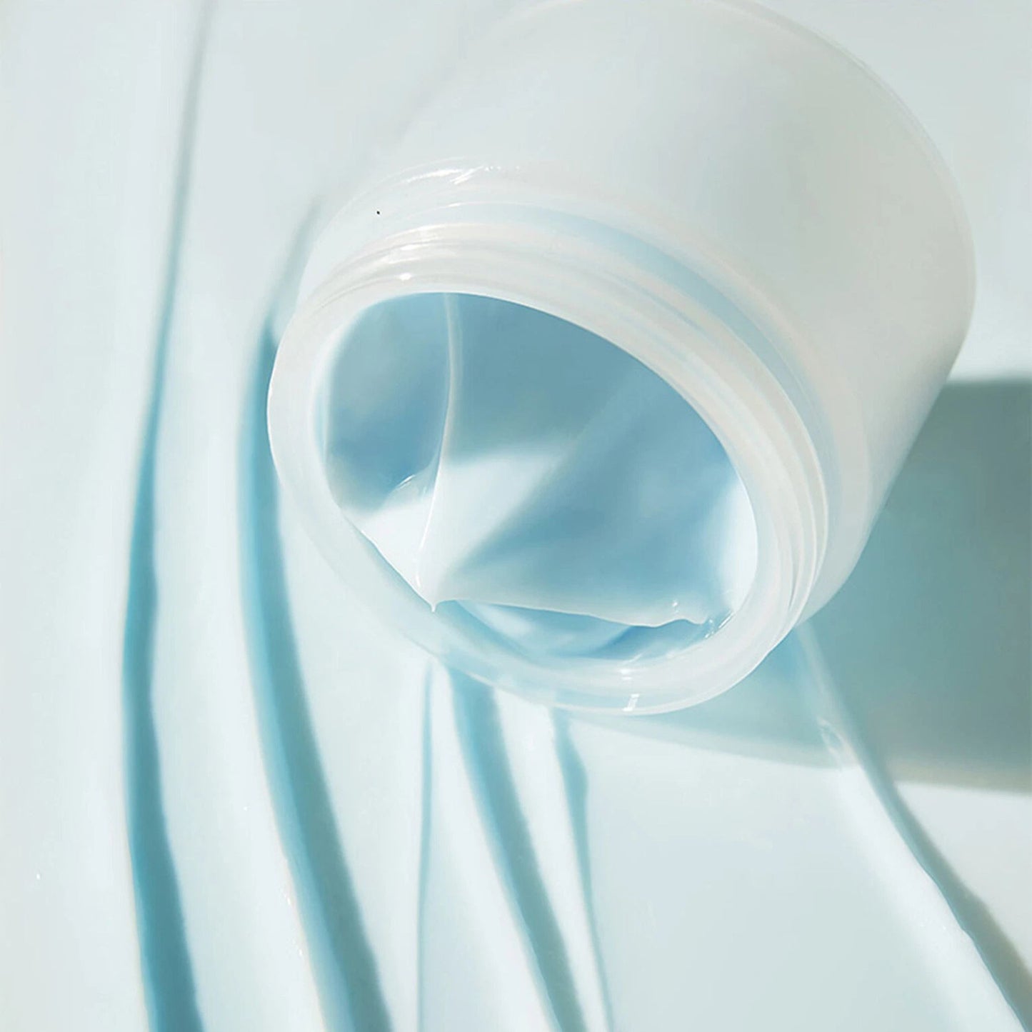 Close-up of a roll of light blue fabric on a white background
