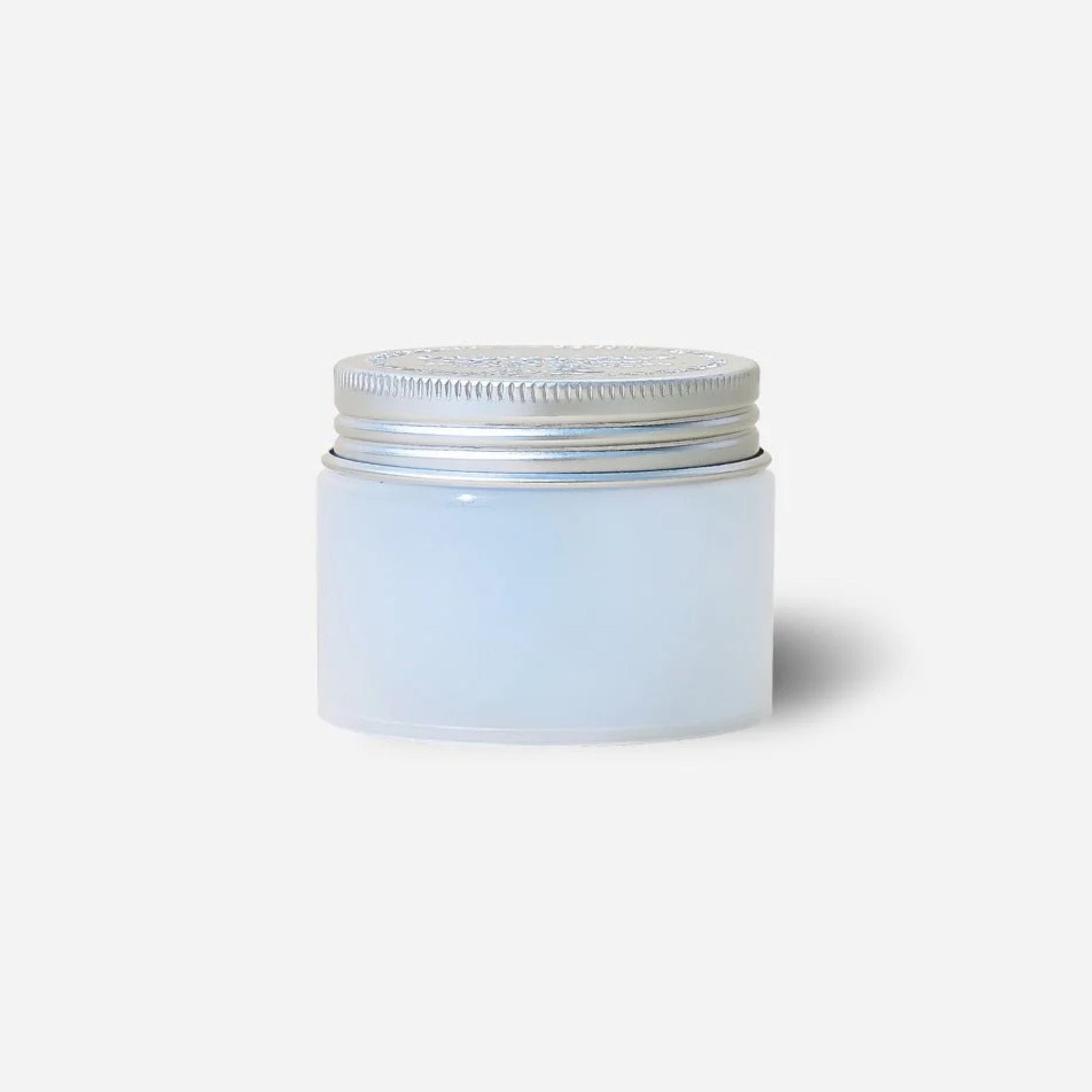 White jar with a silver lid on a light gray background