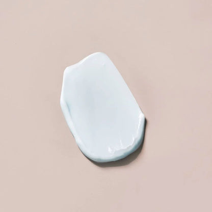 White ceramic object on a beige background