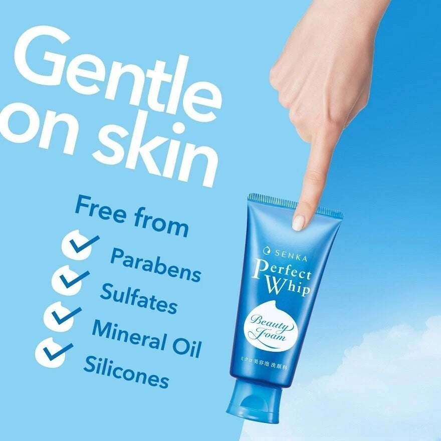 Hand holding a blue skincare product tube with text about gentle ingredients on a blue background