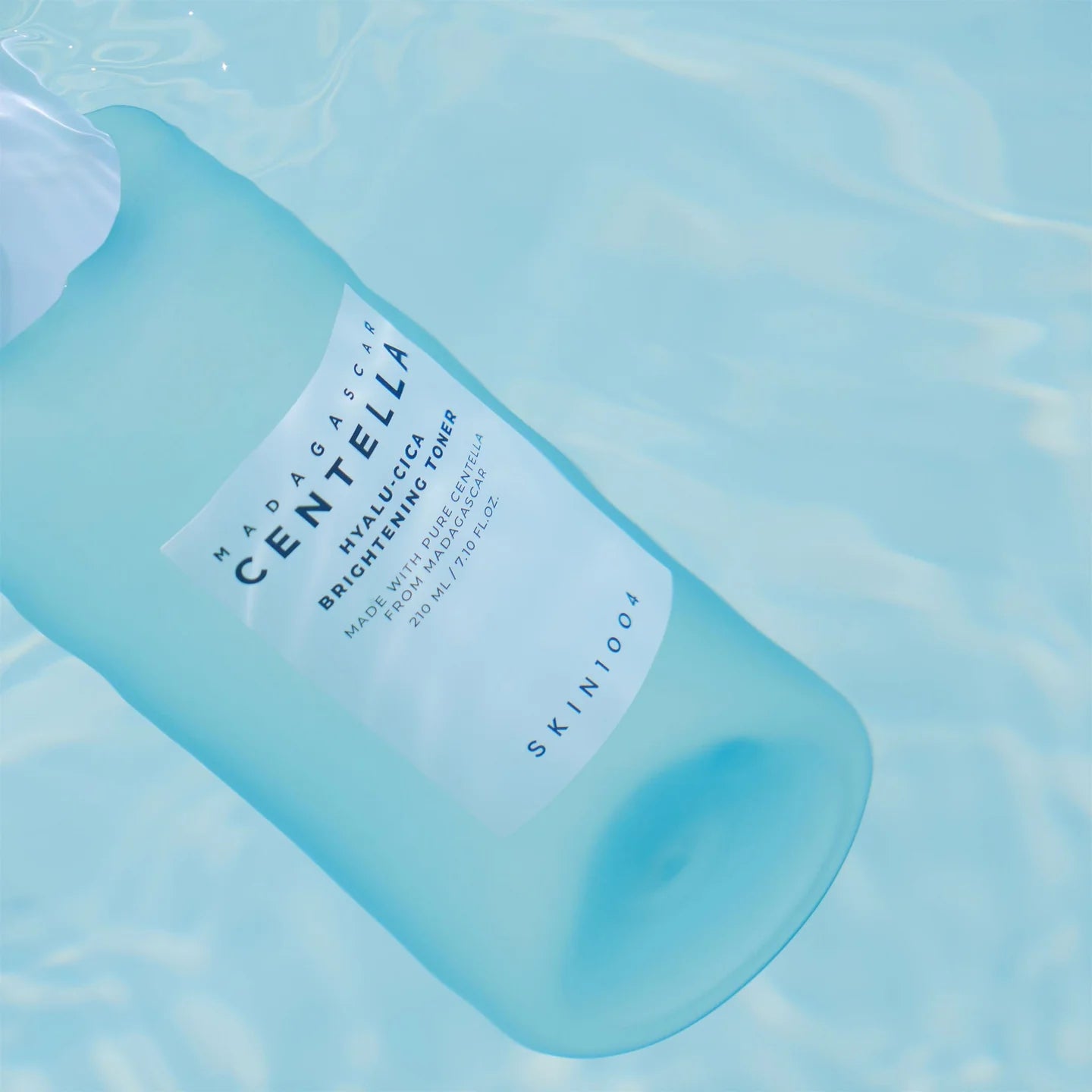 Blue bottle of Skinfood Centella Asiatica Hyaluronic Toner on a light blue background