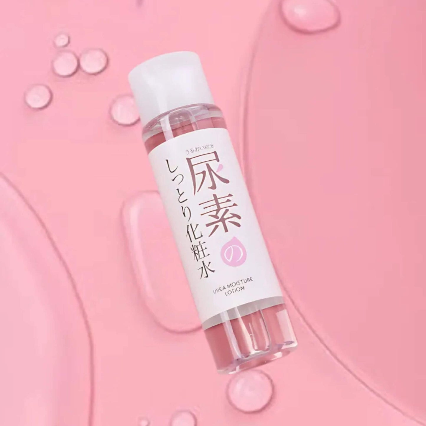 Skincare bottle with Japanese text on a pink background